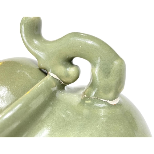 495B - A Chinese celadon glaze lidded centre, three legged with mythical beast finial, ht. 25cm 