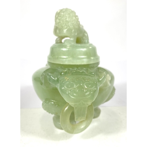 497A - A Chinese jade coloured hardstone censor with hoop handles, mythical beast carved finial and side mo... 