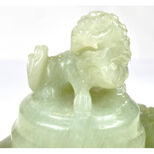 497A - A Chinese jade coloured hardstone censor with hoop handles, mythical beast carved finial and side mo... 