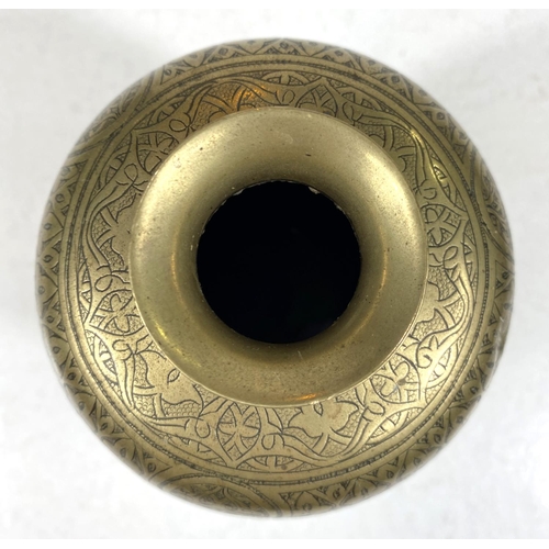 497B - An Islamic brass vase with etched decoration to the outside, tapering and flaring rim, ht. 14.5cm