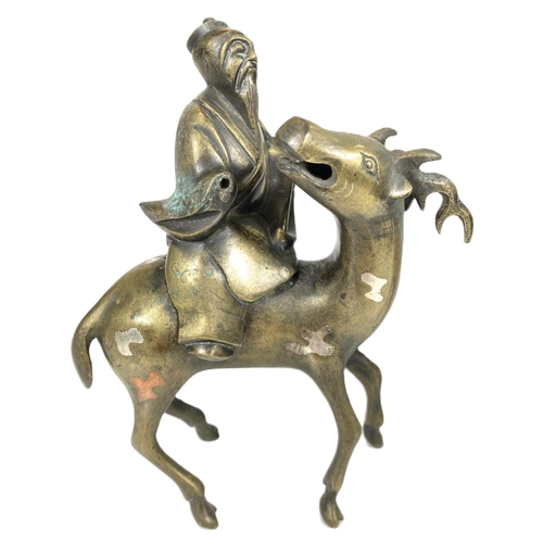 497C - A pair of Chinese brass censors in the form of men riding deer (some loss) ht. 17cm