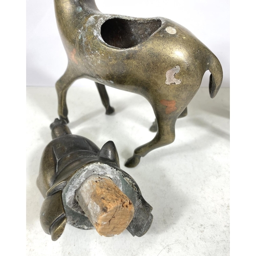 497C - A pair of Chinese brass censors in the form of men riding deer (some loss) ht. 17cm