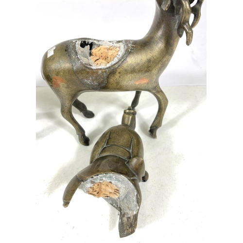 497C - A pair of Chinese brass censors in the form of men riding deer (some loss) ht. 17cm