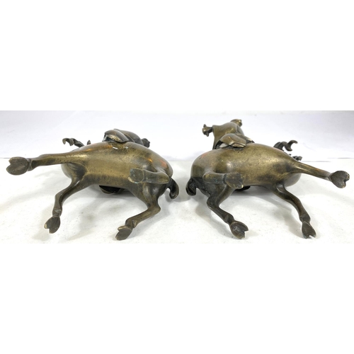 497C - A pair of Chinese brass censors in the form of men riding deer (some loss) ht. 17cm