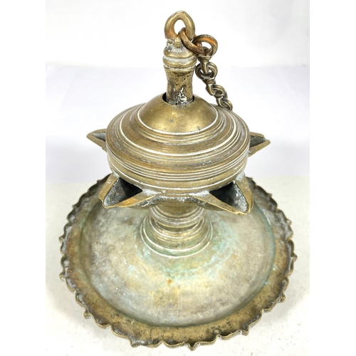 499A - An antique Middle Eastern possibly Islamic oil lamp with five star shaped spouts, ht. 18cm