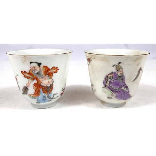 503 - A pair of Chinese famille rose wine cups decorated with deities to the outside, seal mark to base he... 