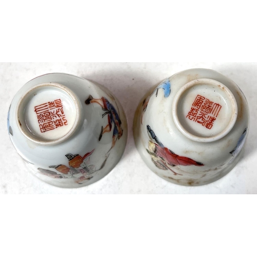 503 - A pair of Chinese famille rose wine cups decorated with deities to the outside, seal mark to base he... 