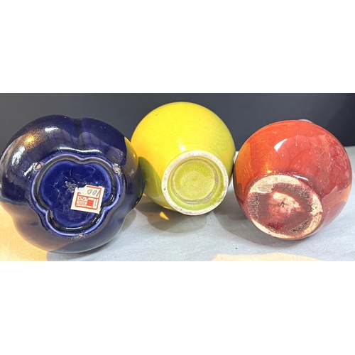 504A - Three small Chinese monochrome vases, yellow and red vases on stands and a dark blue double gourd va... 