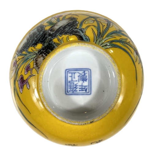 510C - A Chinese yellow ground bowl with polychrome decoration, Chinese characters, seal mark to base