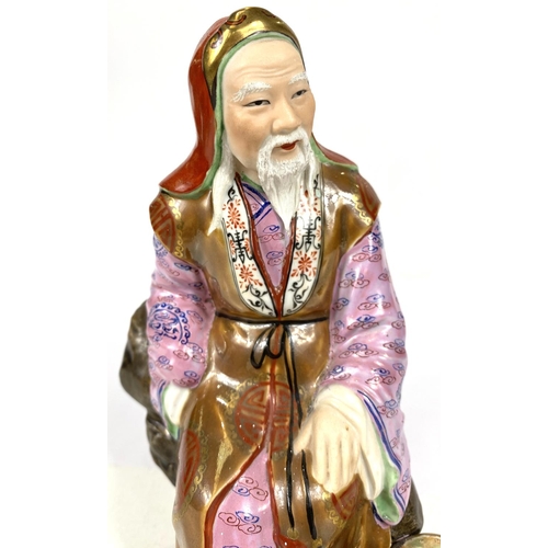 511C - A 20th century Chinese figure of an old man in well decorated clothing, impressed mark to base, ht. ... 