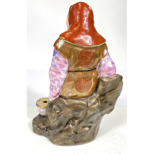 511C - A 20th century Chinese figure of an old man in well decorated clothing, impressed mark to base, ht. ... 