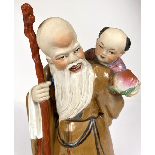 511D - A 20th century Chinese group of old man and young children with fruit, impressed mark to base, ht. 3... 