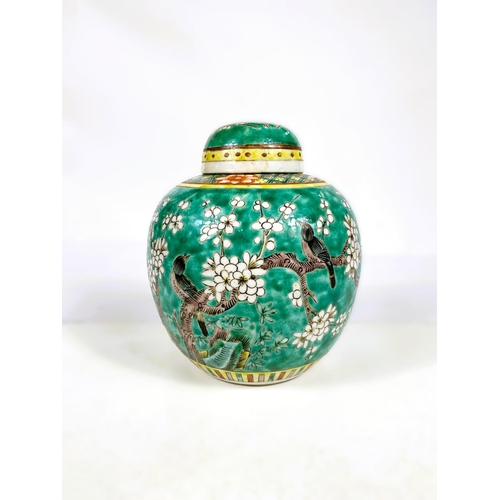 521 - A Chinese green ground ginger jar decorated with flowers, four character painted mark to base, (lid ... 