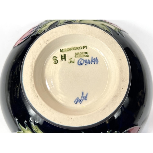 571A - Moorcroft: A modern Moorcroft bowl with dark blue ground anemone decoration, signed JW WM beneath, d... 