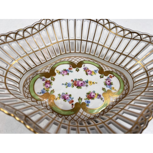 582A - A Dresden oval shaped open work basket with twin handles and gilt and polychrome decoration