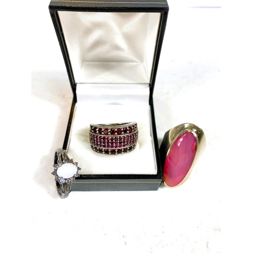 601 - A large silver ring set pink oval stone; a silver ring set red stones; an Art Deco hairpin (a.f.); o... 