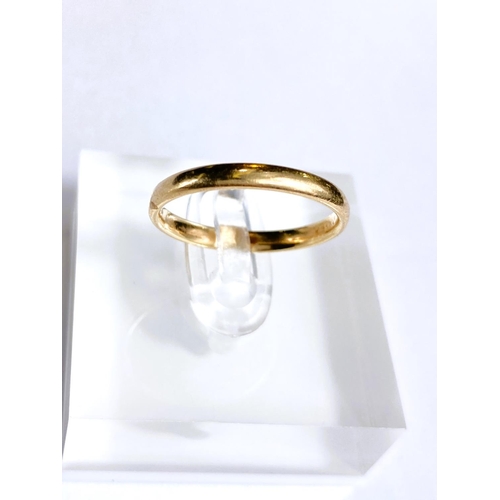 603 - A 9 carat gold wedding band, 1.9gm; an 18 carat gold pair of earring backs, 2.2gm; a 9 carat gold fi... 