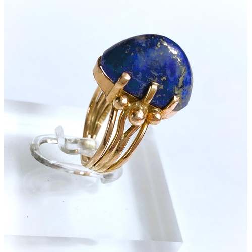 608 - A yellow metal dress ring set yellow seamed lapis lazuli coloured stone, Egyptian marks to shank, 5.... 