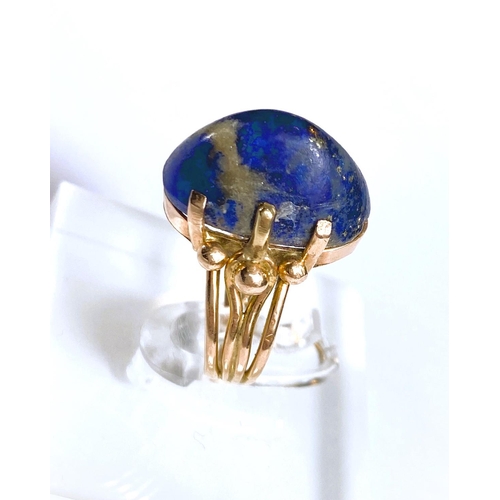 608 - A yellow metal dress ring set yellow seamed lapis lazuli coloured stone, Egyptian marks to shank, 5.... 