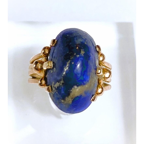 608 - A yellow metal dress ring set yellow seamed lapis lazuli coloured stone, Egyptian marks to shank, 5.... 