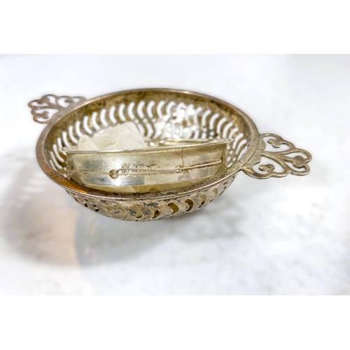 610 - A hallmarked silver vesta case, monogrammed; a silver rimmed strainer; a pierced silver bonbon dish,... 