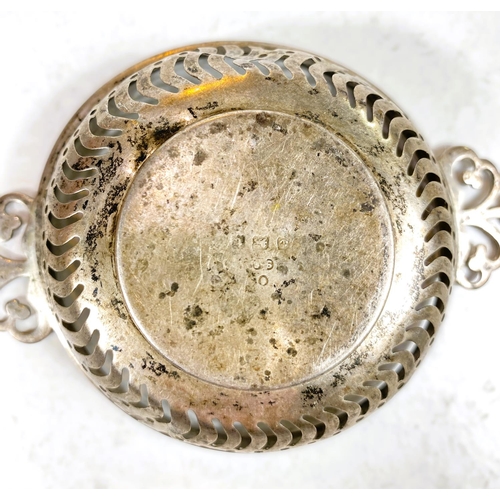 610 - A hallmarked silver vesta case, monogrammed; a silver rimmed strainer; a pierced silver bonbon dish,... 