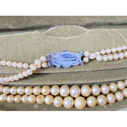 618 - A collection of Majorica pearl necklaces and bracelets, some with boxes, other simulated and other p... 