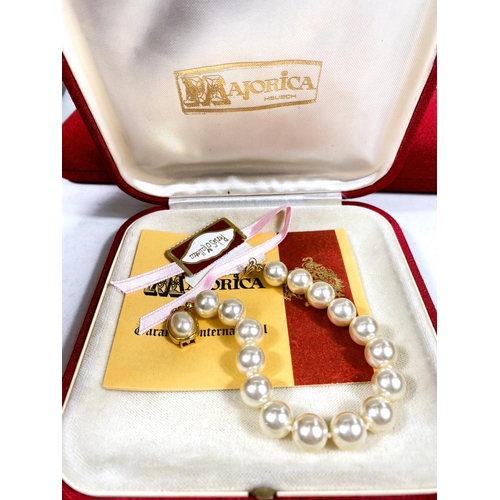 618 - A collection of Majorica pearl necklaces and bracelets, some with boxes, other simulated and other p... 