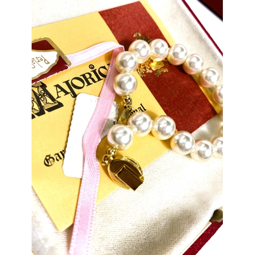 618 - A collection of Majorica pearl necklaces and bracelets, some with boxes, other simulated and other p... 