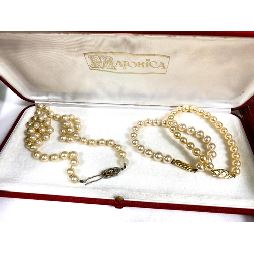 618 - A collection of Majorica pearl necklaces and bracelets, some with boxes, other simulated and other p... 