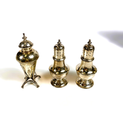 630 - A hallmarked silver pair of dome top pepper pots on pedestal bases, cased, marks worn. An Art Nouvea... 