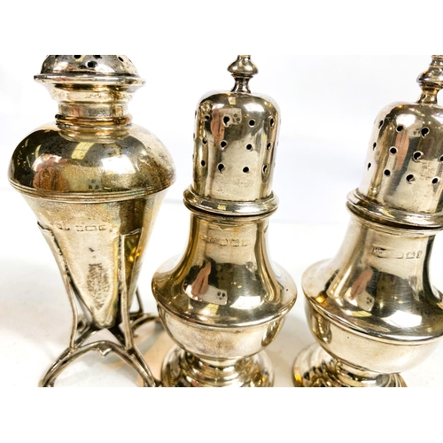 630 - A hallmarked silver pair of dome top pepper pots on pedestal bases, cased, marks worn. An Art Nouvea... 