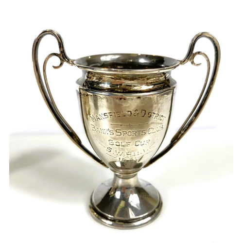 631 - Four hallmarked silver items:  a 2-handled trophy cup; a christening mug; a small trophy cup; a... 