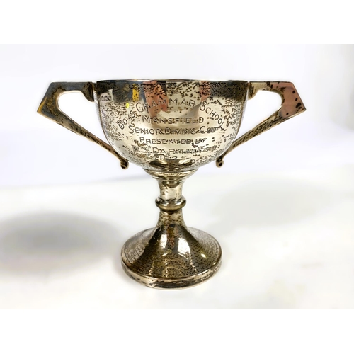 631 - Four hallmarked silver items:  a 2-handled trophy cup; a christening mug; a small trophy cup; a... 