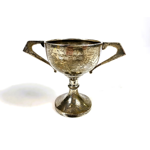 631 - Four hallmarked silver items:  a 2-handled trophy cup; a christening mug; a small trophy cup; a... 