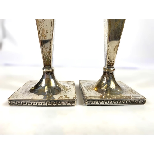 634 - A hallmarked silver pair of candlesticks with square tapering columns on square weighted bases, Shef... 