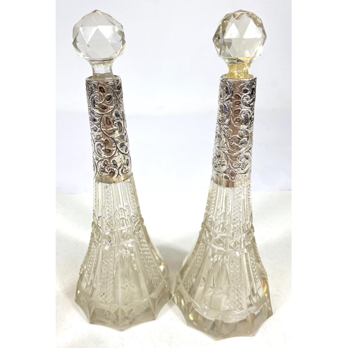 641 - A pair of cut glass slender scent bottles with hallmarked silver collars (1 stopper a.f.); a scent b... 