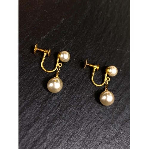 657 - A yellow metal pair of screw earrings, each set with a large and small cultured pearl; a similar pai... 