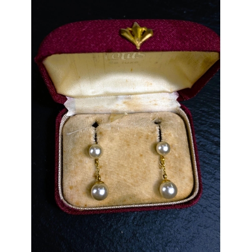 657 - A yellow metal pair of screw earrings, each set with a large and small cultured pearl; a similar pai... 