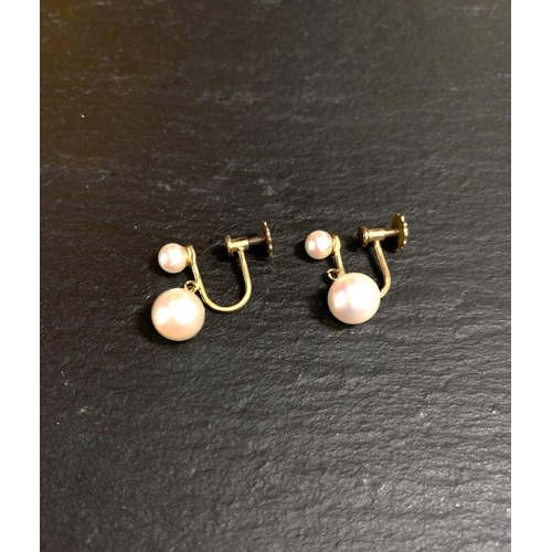 657 - A yellow metal pair of screw earrings, each set with a large and small cultured pearl; a similar pai... 