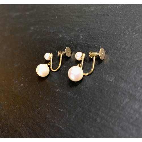 657 - A yellow metal pair of screw earrings, each set with a large and small cultured pearl; a similar pai... 