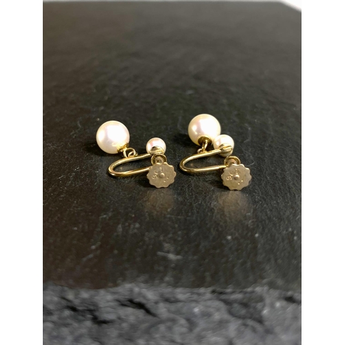 657 - A yellow metal pair of screw earrings, each set with a large and small cultured pearl; a similar pai... 