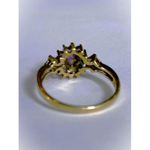 668 - A yellow metal wide ring, stamped 375, with Greek key style decoration, set oval peridot coloured st... 