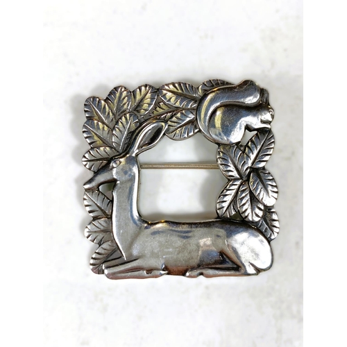 675 - Georg Jensen:  a silver square brooch with doe and squirrel in foliage, stamped Georg Jens... 