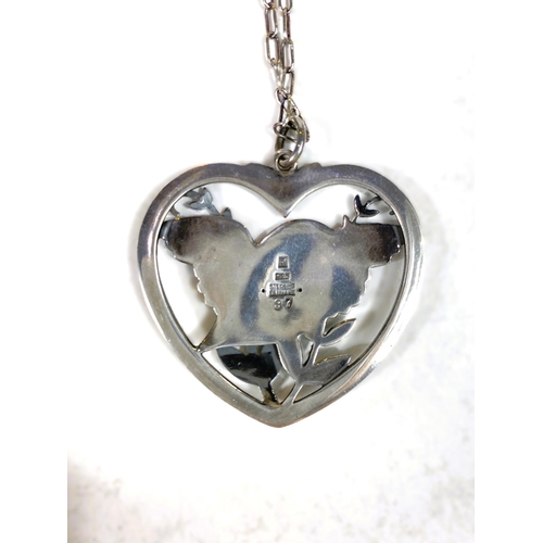 678 - Georg Jensen:  a pierced silver heart shaped pendant, bird with outstretched wings perched in b... 