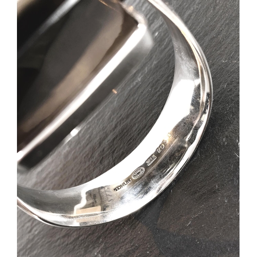 679 - Georg Jensen:  a tapering silver bangle, designed by Vivianna Torun Bülow-Hübe, the top set large sq... 