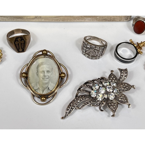 694 - A hallmarked silver signet ring with red stone set, another silver leaf ring and a selection of cost... 