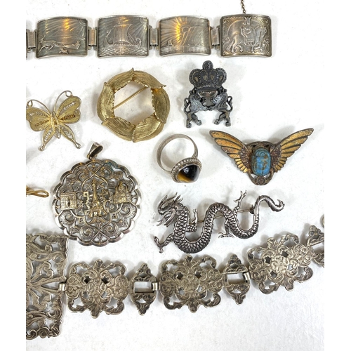 695 - A Chinese white metal dragon brooch stamped 925; a white metal continental bracelet with Viking ship... 