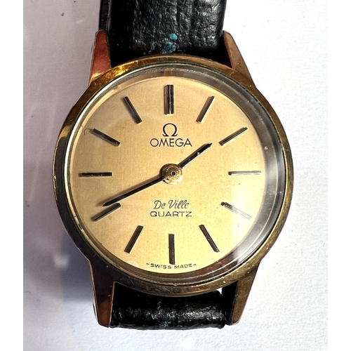 705 - A lady's Omega wrist watch, another Omega De Ville lady's wrist watch and a Raymond Weil watch in an... 