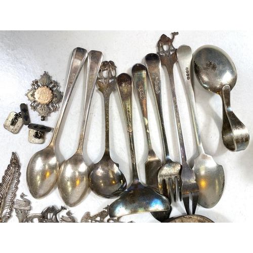 706 - A selection of hallmarked silver napkin rings, tea spoons and various white metal and EPNS items.